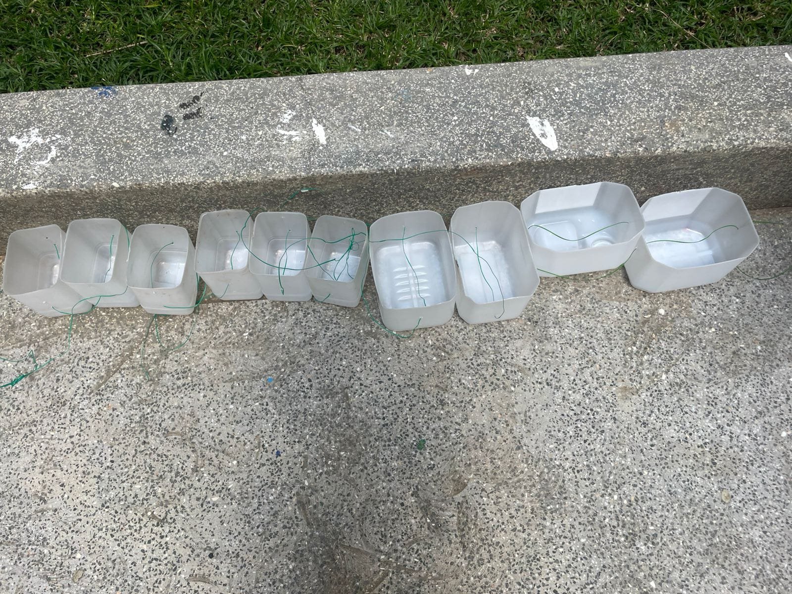 A sack of empty, dusty plastic bottles collected from homes