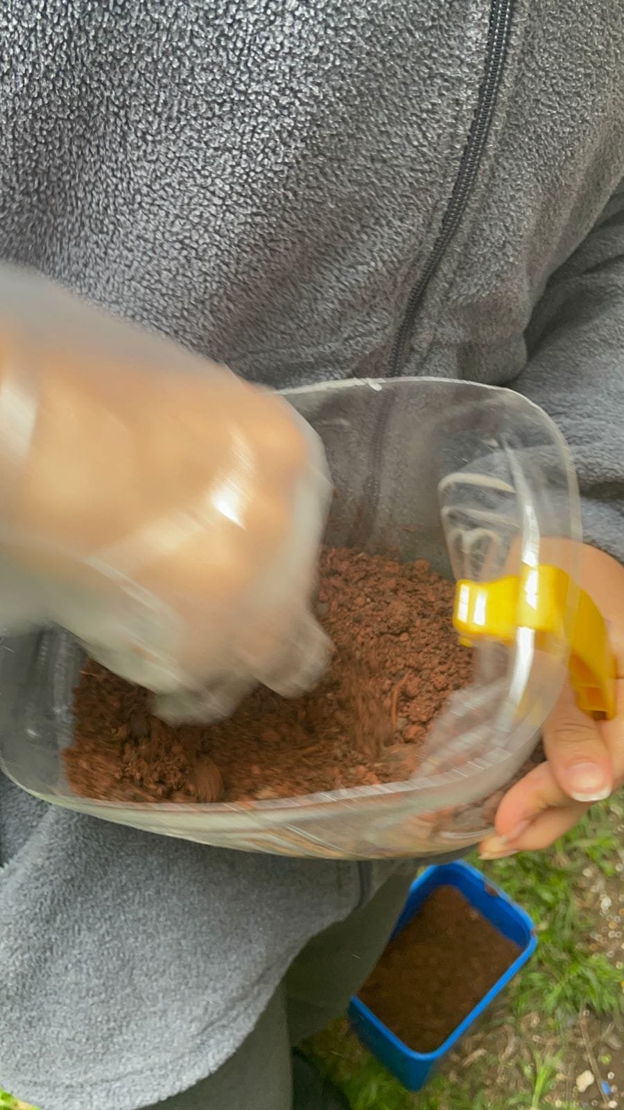 Bottles being filled with a soil and compost mix